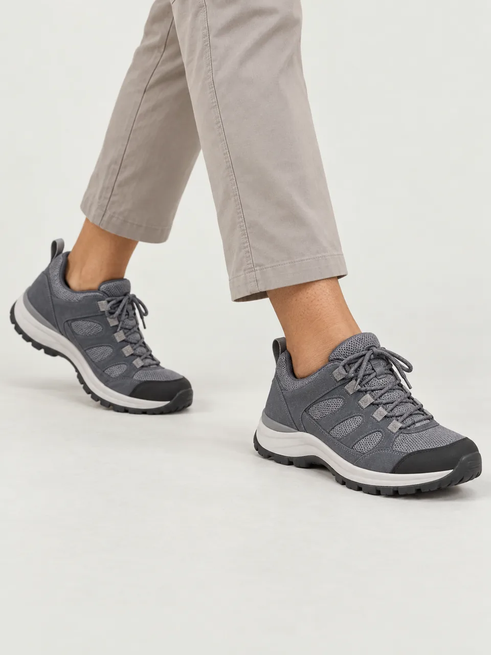 Woman in her 30s, South Asian, petite, walking a reservoir path in cropped trousers, framed from the knee down wearing the Hale Women's Dub Waterproof Walking Shoe in Slate