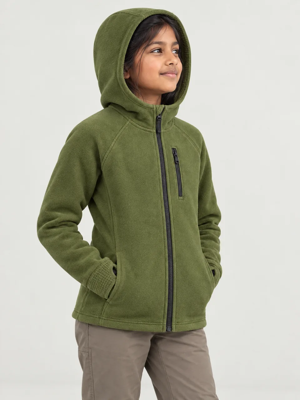 Girl about 10, South Asian, standing side-on at a rocky summit with the hood up, looking at the view wearing the Hale Kids' Nab Hooded Grid Fleece in Moss