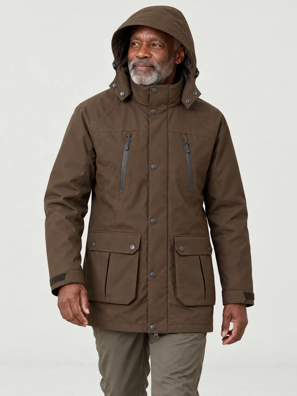 Black man in his 60s, walking with his hands relaxed at his sides, hood up wearing the Hale Men's Garth 2L Long Waterproof Jacket in Peat
